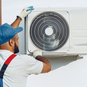 repairman-in-uniform-installing-the-outside-unit-o-2021-09-03-18-54-04-utc-1